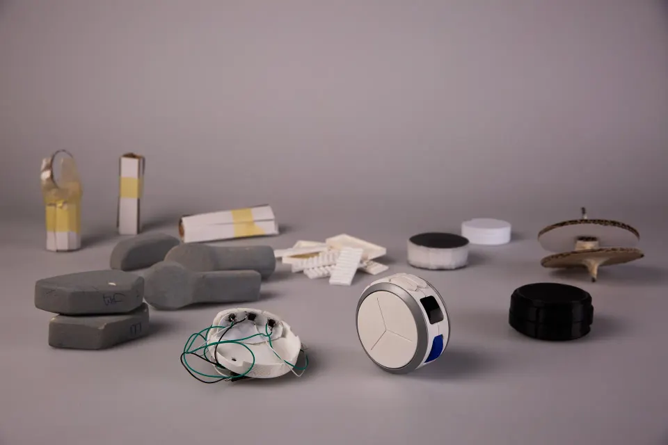 Foam, paper and printed models lined up on a grey backdrop